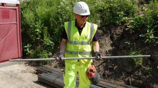 Senior site engineer Chris Williams holding a 3m (10ft) section of a soil nail