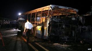 Investigators examine bus in city of Xiamen. 7 June 2013
