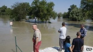 Locals survey flooded River Danube in Domos village, west of Budapest 08/06