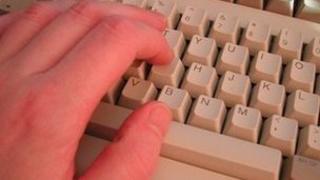 Hand typing on keyboard