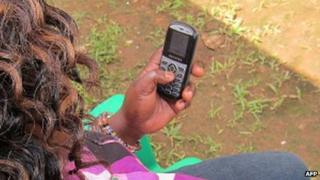 A woman using a mobile phone in Uganda - July 2012