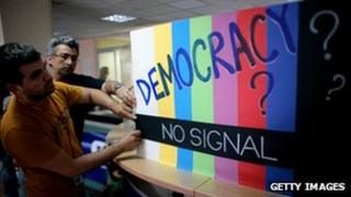 ERT employees secure a protest banner