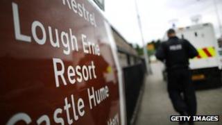 A policeman walks past a sign pointing to the Lough Erne Resort - location of the G8 summit