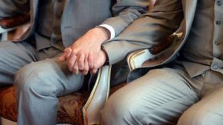 Gay couple holding hands