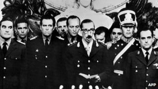 General Orlando Ramon Agosti (R) and Admiral Emilio Massera (L) stand as Lieutenant General Jorge Rafael Videla (C), President of Argentina, takes an oath as 38th president of the Argentine Republic, 29 March 1976, in Buenos Aires.