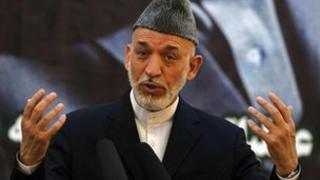 Afghan President Hamid Karzai speaks during a news conference, 18 June