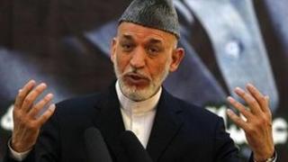 Afghan President Hamid Karzai speaks during a news conference, 18 June