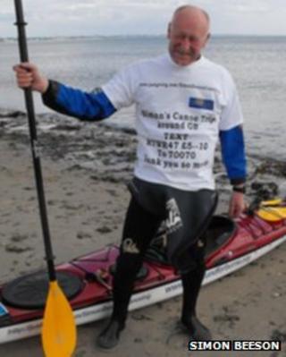 Simon Beeson next to his kayak