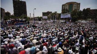 Egyptian Islamist groups led by the ruling Muslim Brotherhood take part in a demonstration to mark the upcoming one year anniversary since President Mohamed Morsi (portrait) was elected.