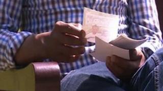 Berhane with a photo of his relative
