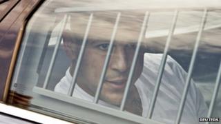 New England Patriots tight end Aaron Hernandez is led out of the North Attleborough police station after being arrested 26 June 2013