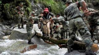 Army soldiers rescue a woman at Pindari Glacier, in Uttarakhand, on June 27, 2013