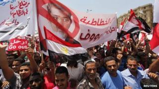 Protesters opposing Egyptian President Mohamed Morsi hold up a banner during a protest at Tahrir Square in Cairo