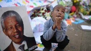 People gather for Nelson Mandela outside the Mediclinic Heart Hospital where he is being treated for a lung infection on June 30, 2013 in Pretoria, South Africa.