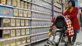 A Chinese mother looking at baby milk formula in a store in China