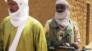 Fighters with the MNLA (National Movement for the Liberation of Azawad) stands guard as members of the group met with the Malian army, the UN mission in Mali and French army officers, in Kidal June 23, 2013