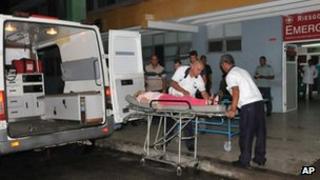 Ambulance workers take a woman injured in the bus crash, into the hospital in Cienfuegos, Cuba