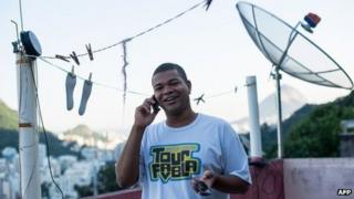 Brazilian on the phone in Rio favela