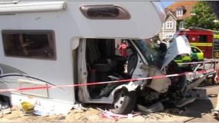 Police cordon surrounds crumpled front of motorhome