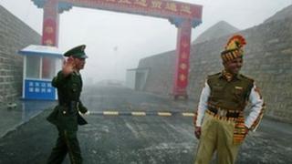 In this photograph taken on July 10, 2008, a Chinese soldier (L) and an Indian soldier stand guard at the Chinese side of the ancient Nathu La border crossing between India and China.