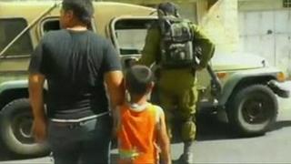 Wadi Maswadeh being led to an Israeli army jeep