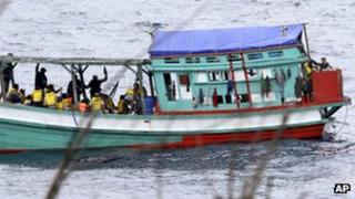 File photo: a fishing boat carrying Vietnamese asylum seekers nears the shore of Australia"s Christmas Island on 14 April 2013