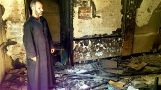 Father Ayoub Youssef in his burned-out church