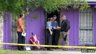 Police investigate a home where it was reported that four elderly men were held against their will in Houston on 19 July 2013
