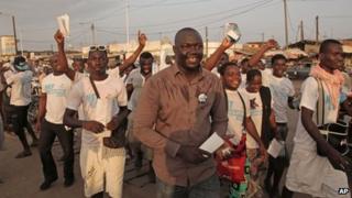 Gerry Taama (C) from the New Togolese Engagement party campaigns at a local market ahead of legislative elections in Lome, Togo