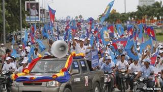 Supporters of the Cambodian People Party march along a street during an election rally in central Phnom Penh, 21 July 2013