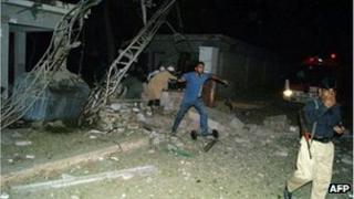 Pakistani security members are pictured at the site of suicide car bombing in the southern city of Sukkur on 24 July
