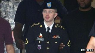 Pte Bradley Manning is escorted out of a courthouse at Fort Meade in Maryland, 18 July 2013