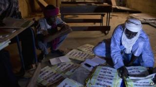 Election workers count votes at a station in Mali