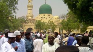 A crowd wait outside the central mosque in the northern Nigeria city of Kano in May 2012