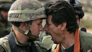 A Palestinian man argues with an Israeli soldier during a demonstration against Israel's separation barrier at the village of Bilin, near the West Bank city of Ramallah (2007 file image)