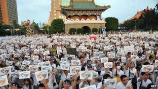 Protesters hold placards at an anti-military rally in front of Taiwan's presidential office in Taipei