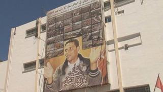 Poster of Mohammed Bouazizi hanging across the post office building in the city
