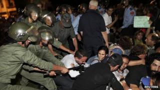 Protesters clash with riot police during a demonstration in Rabat on 2 August 2013