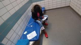 A woman in a police cell