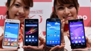 Models display various smartphones
