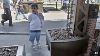 A boy looks at a show-window of Roshen sweet manufacturer shop in Kiev, Ukraine