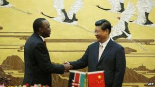 Kenya's President Uhuru Kenyatta and China's President Xi Jinping shake hands in Beijing on 19 August 2013