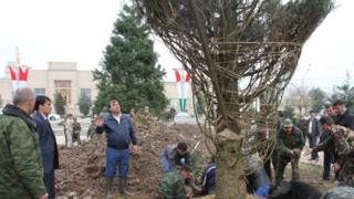 Tajik President Emomali Rakhmon oversees a tree planting ceremony in Dushanbe