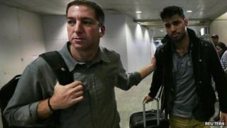 Glenn Greenwald (left) and his partner David Miranda (right) were reunited when Mr Miranda arrived back in Brazil