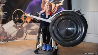 Shelly Woods holds up a revolutionary new racing wheel
