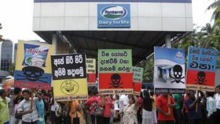 Sri Lankan demonstrators shout slogans during a protest against Fonterra products in front of the main factory in Biyagama, about 21 km (14 miles) from capital Colombo, August 22, 2013.
