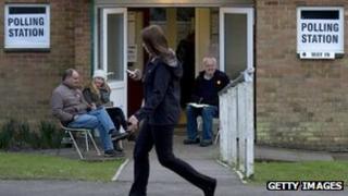A woman passes a polling station