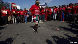 Members of the Nation Union of Metalworkers of South Africa sing as they continue to strike at the Toyota plant in Durban, August 23, 2013.