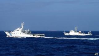 Japan's coast guard ship (left) sails along China's marine surveillance near the disputed islands in the East China Sea. File photo