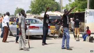 Vigilantes from the "Civilian Joint Task Force" group man a checkpoint in Maiduguri, Nigeria armed with with cutlasses and clubs on 7 August 2013 (file image)
